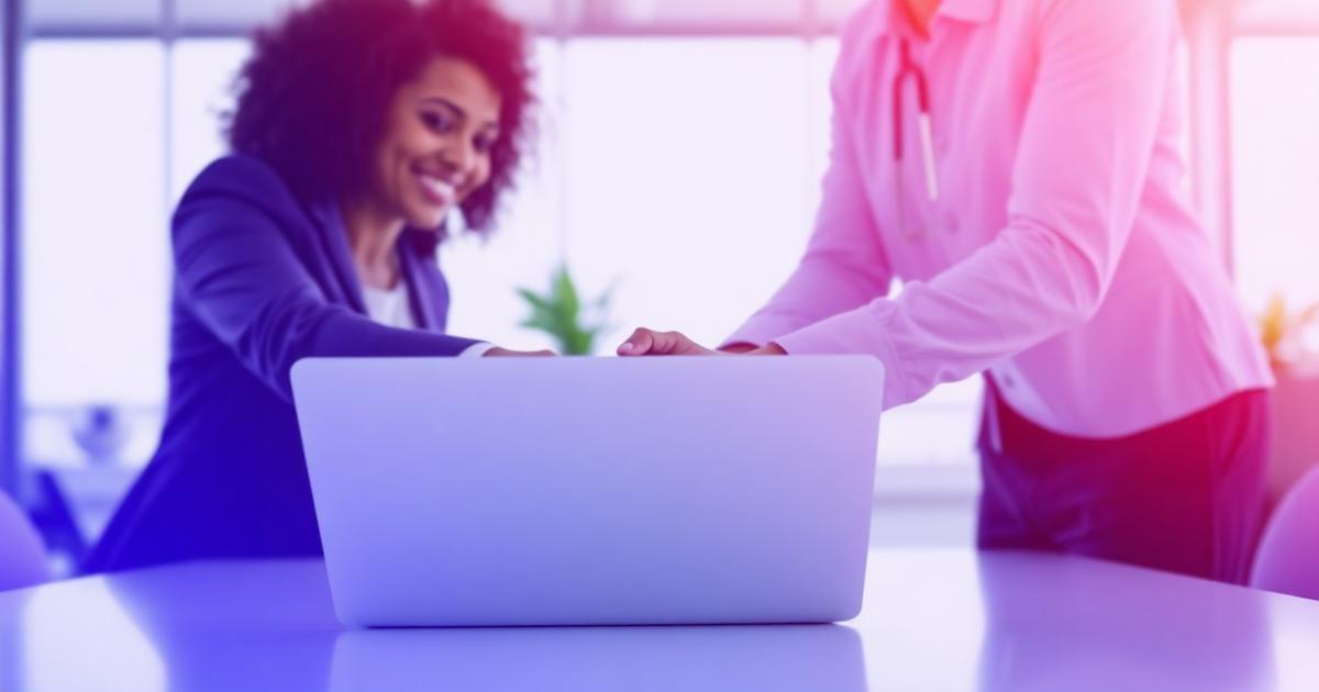 Two professionals meeting over a laptop in a bright office